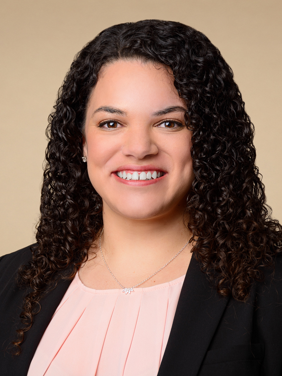 Professional female realtor headshot in NYC studio against beige background
