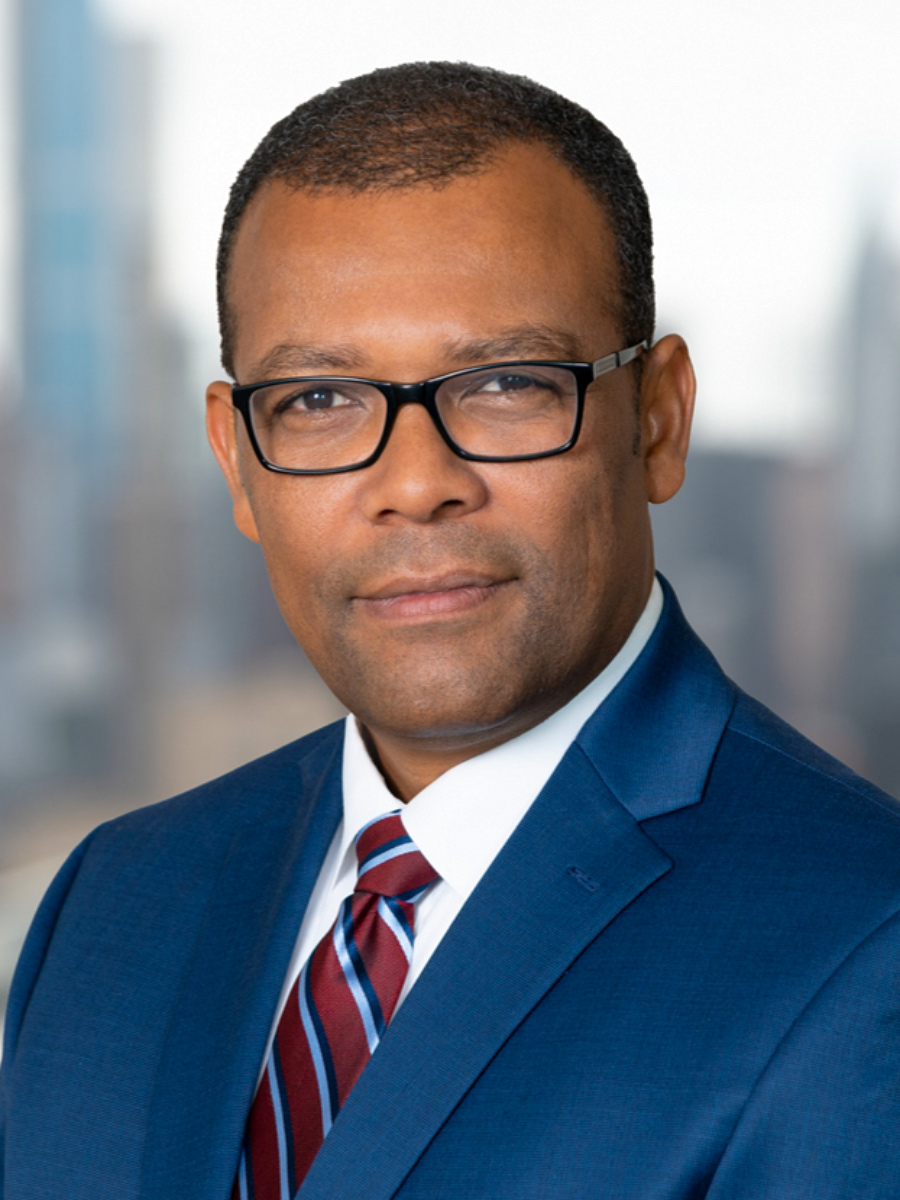 NYC realtor headshot taken outdoors with manhattan skyline in background, male real estate agent