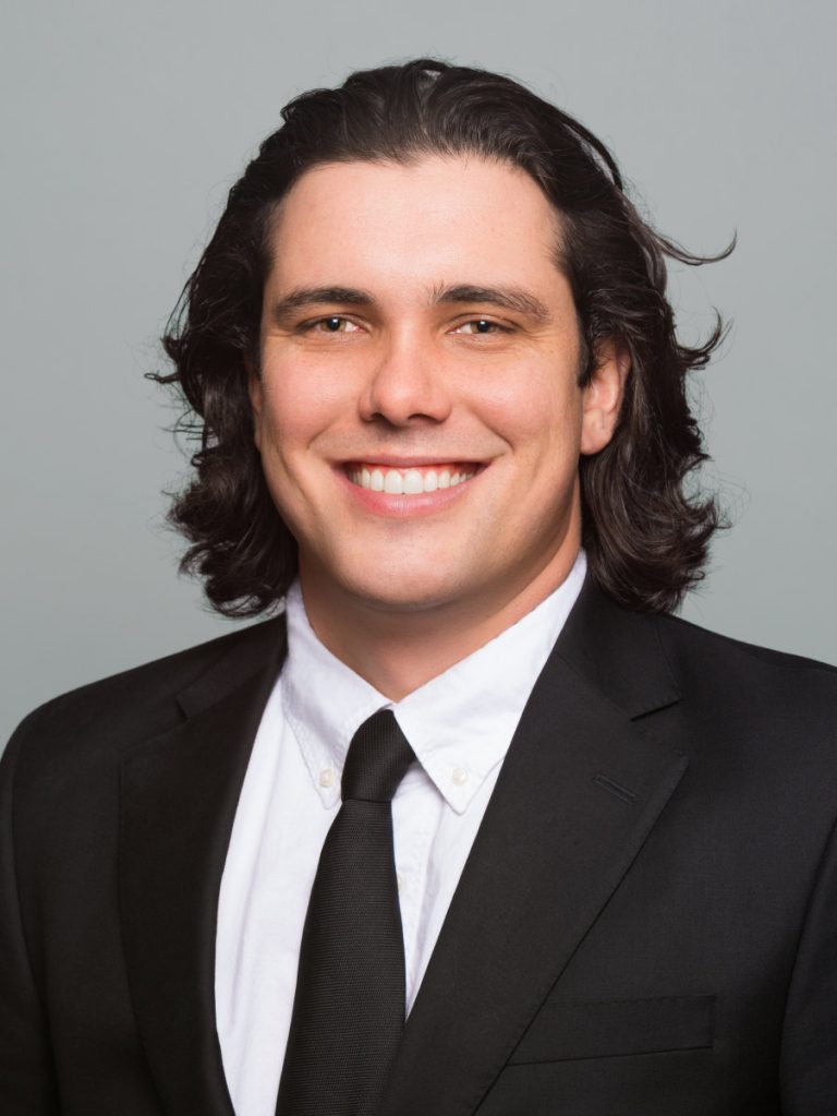 Studio portrait of a male financial professional on a light background in NYC