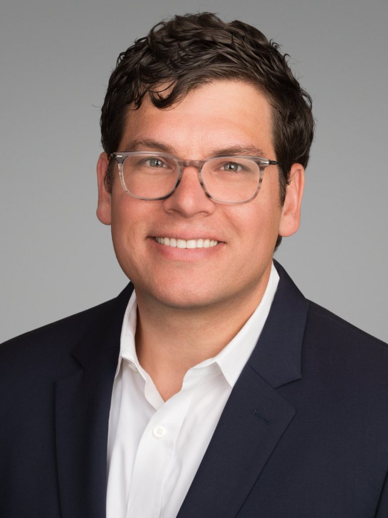 Professional portrait of a male financial professional on a light background in Midtown NYC